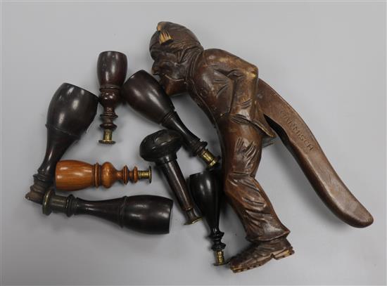 A pair of carved nut crackers and a collection of treen seals